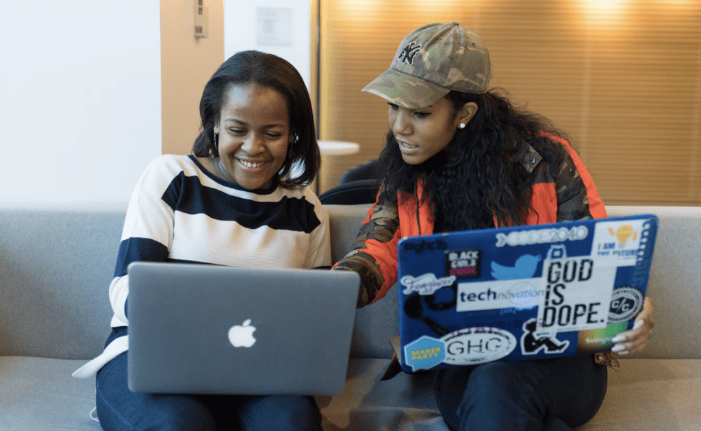 2 women sitting down with laptops